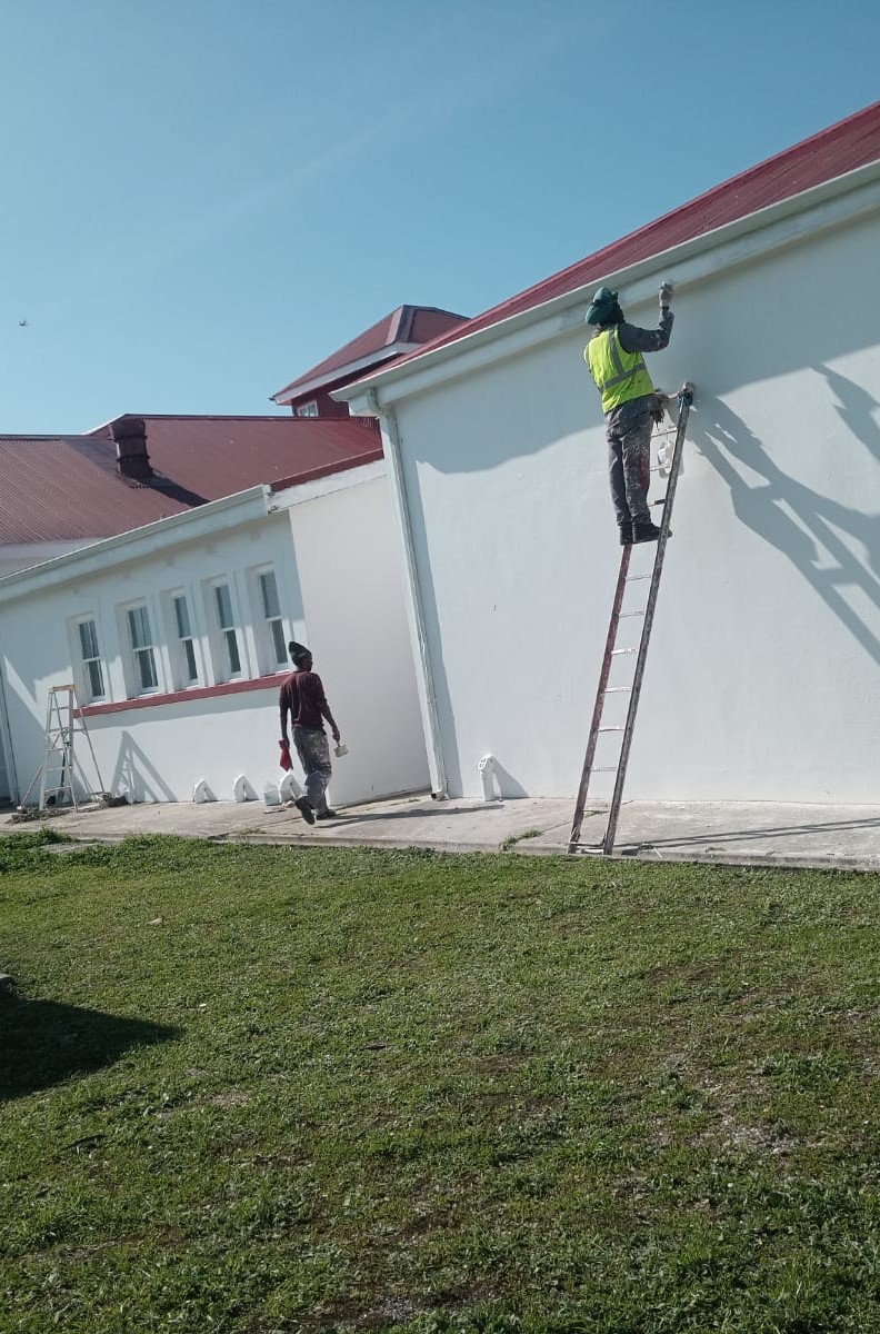 Elton Tree Felling team painting the exterior of a building